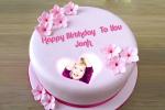 Write a greeting on the pink birthday cake with Photo